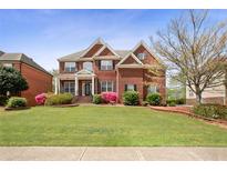 Beautiful two-story brick home with well-manicured lawn and colorful landscaping at 295 Langshire Dr, Mcdonough, GA 30253