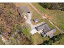 Stunning aerial view of a secluded home and property with a large outbuilding at 111 Ayers Driver Rd, Villa Rica, GA 30180