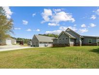 Spacious property with well-maintained landscaping, a modern home design, and convenient outbuildings and garages at 111 Ayers Driver Rd, Villa Rica, GA 30180