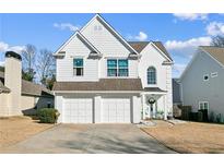 Charming two-story home features a two-car garage, white siding, and a well-maintained front yard in a desirable location at 1240 Birchwood Ln, Roswell, GA 30076