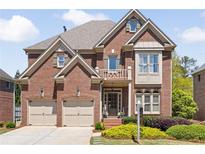 Charming two-story brick home with manicured landscaping, two-car garage, and inviting front entrance at 1662 Hartford Ne Gln, Atlanta, GA 30319