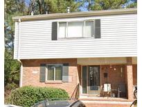 Charming townhouse featuring brick and siding facade, complemented by black shutters and a cozy front porch at 3346 Northcrest Rd # A, Atlanta, GA 30340