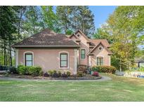 Charming one-story home featuring a well-manicured lawn and mature landscaping in a suburban setting at 125 Russell Rd, Lawrenceville, GA 30043