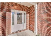 Inviting front entrance with decorative glass door and classic red brick facade at 4066 Wild Orchid Ln, Loganville, GA 30052