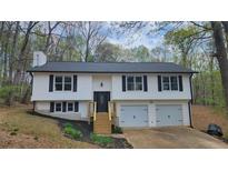 Charming, two-story home with a freshly painted exterior and attached two car garage at 1504 Kimberly Pl, Canton, GA 30114