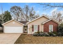 Charming single-story home featuring a two-car garage and brick accents at 208 Roberts Trl, Locust Grove, GA 30248