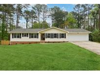 Charming single story home with a sprawling front lawn and a two car garage at 756 Butler Ct, Lawrenceville, GA 30044