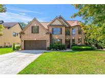 Charming brick two-story home with a well-manicured lawn and attached two-car garage at 2369 Apalachee Crucis Ln, Dacula, GA 30019