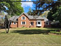 Charming two-story red brick home with a well-maintained lawn and mature trees at 3175 Old Jonesboro Rd, Fairburn, GA 30213