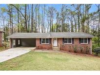 Charming single-story brick home with a welcoming front yard and a convenient carport at 3773 Sarahs Ln, Tucker, GA 30084