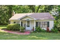 Charming single-story home with a well-maintained lawn and lush landscaping in a peaceful, wooded neighborhood at 3750 Mckown Rd, Douglasville, GA 30134