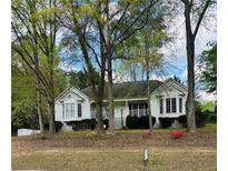 Charming white home featuring well-maintained landscaping and a welcoming covered front porch at 30 Dogwood Trl, Dallas, GA 30157