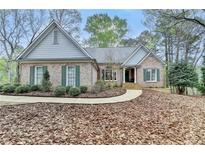 Charming single-story brick home featuring a well-maintained lawn and inviting walkway at 3230 Riverhill Ct, Cumming, GA 30041