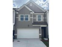 Charming townhome featuring a two-car garage and stylish gray siding at 6426 Rosetta Drive # 53, South Fulton, GA 30331
