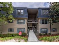 Inviting exterior of multi-level condo building with blue shutters and well-maintained landscaping at 177 Nw Amherst Pl, Atlanta, GA 30327