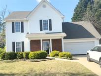 Charming two-story home boasts white siding, black shutters, and a well-manicured lawn at 3058 Arden Ridge Ter, Suwanee, GA 30024