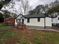 Charming single-story home featuring a freshly painted white brick exterior, a blue door, and a neatly landscaped front yard at 2665 Northview Ave, Decatur, GA 30032