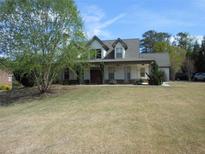 Charming two-story home with a spacious front yard and inviting front porch at 325 Brook Hollow Ln, Loganville, GA 30052