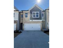 Charming brick townhome with a two-car garage, well-maintained landscaping, and inviting curb appeal at 5645 Hislop Ln # 89, Mableton, GA 30126