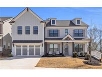 Charming two-story home showcasing a manicured lawn and a spacious two-car garage at 1501 Branthaven Ln, Auburn, GA 30011