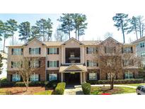 Inviting multi-Gathering home showcasing manicured lawns and warm-toned brick and siding at 4203 Fairington Village Dr, Lithonia, GA 30038