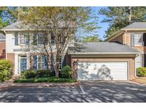 Charming two-story home with attached garage and blue shutters at 629 Pinetree Dr, Decatur, GA 30030