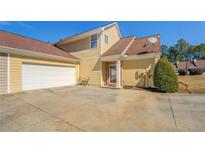 Two-story home featuring a two-car garage and well-maintained lawn at 202 Accord Ln, Grayson, GA 30017