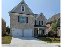 Charming two-story brick home featuring a two-car garage and well-manicured lawn at 795 Clark Lake Estates Dr, Grayson, GA 30017