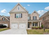 Beautiful two-story brick home with a two-car garage and well-manicured lawn at 795 Clark Lake Estates Dr, Grayson, GA 30017