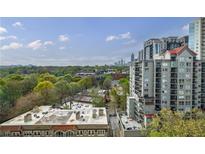 Scenic city view overlooking lush green trees with modern high-rise buildings in the background on a clear day at 1130 Piedmont Ne Ave # 1407, Atlanta, GA 30309