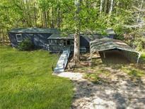 Exterior view of home featuring a metal carport and front porch entrance at 3541 Hutcheson Ferry Rd, Whitesburg, GA 30185