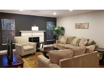 Comfortable living room features a fireplace, natural light, and stylish furnishings at 1804 Huntingdon Chase # 1804, Atlanta, GA 30350