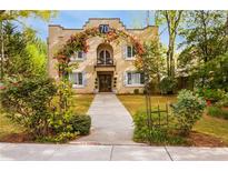 Charming stucco home with lush landscaping and a welcoming floral archway over the entrance at 70 Sheridan Ne Dr # 10, Atlanta, GA 30305
