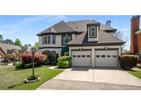 Elegant two-story home boasting a well-manicured lawn, two-car garage and manicured landscaping at 341 Declaire Ne Way, Marietta, GA 30067
