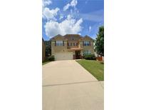 Charming two-story home featuring a large driveway, two-car garage, and well-maintained landscaping at 5243 Cantbury Way, Atlanta, GA 30349