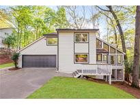 Charming home featuring a well-maintained yard and attached garage at 330 Spring Lake Ter, Roswell, GA 30076