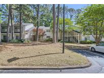 View of charming townhomes with mature trees, landscaping and a paved walkway at 63 Fair Haven Se Way, Smyrna, GA 30080