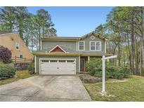 Charming two-story home featuring a well-maintained lawn, attached garage, and beautiful landscaping at 3765 Clear Lake Nw Way, Acworth, GA 30101