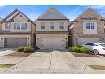Charming brick townhome with attached garage and well-maintained landscaping at 8335 Village Pl, Suwanee, GA 30024