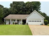 Charming single-story home with a well-manicured lawn and attached two-car garage at 1552 Longwood Dr, Lawrenceville, GA 30043
