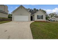 Charming single-Gathering home features a two-car garage, well-maintained lawn and driveway at 100 Chartres St, Dallas, GA 30157