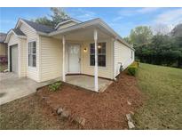 Charming home featuring a covered front porch and well-maintained lawn at 4661 Cedar Park Trl, Stone Mountain, GA 30083