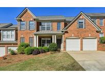 Charming brick home featuring a well-manicured lawn and a two-car garage, perfect for Gathering living at 132 Westchester Se Dr, Smyrna, GA 30082