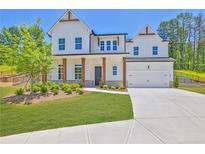 Beautiful two-story home with white siding, manicured lawn, and inviting front porch at 399 Tillman Pass, Woodstock, GA 30188
