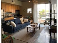 Bright, open living space featuring a comfortable couch, modern decor, and large windows with city views at 620 Glen Iris Ne Dr # 401, Atlanta, GA 30308
