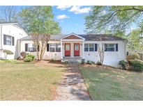 Charming duplex-style home with a well-maintained lawn and mature trees at 1509 Stone Gate Ln, Atlanta, GA 30317