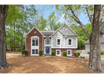 Charming two-story home features a well-manicured front yard and beautiful brick and siding accents at 3450 N Cook Rd, Powder Springs, GA 30127