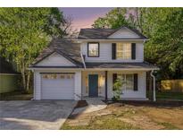 Charming two-story home with white siding, black shutters, and a well-manicured front yard at 3527 Clare Cottage Sw Trce, Marietta, GA 30008