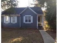 Charming single-story home with blue siding and white trimmed windows in a well-maintained yard at , Marietta, GA 30008