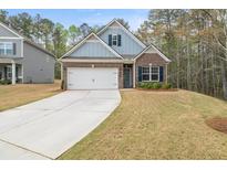 Charming single-Gathering home featuring a well-manicured lawn, two-car garage, and inviting facade at 1037 Devon Dr, Acworth, GA 30102